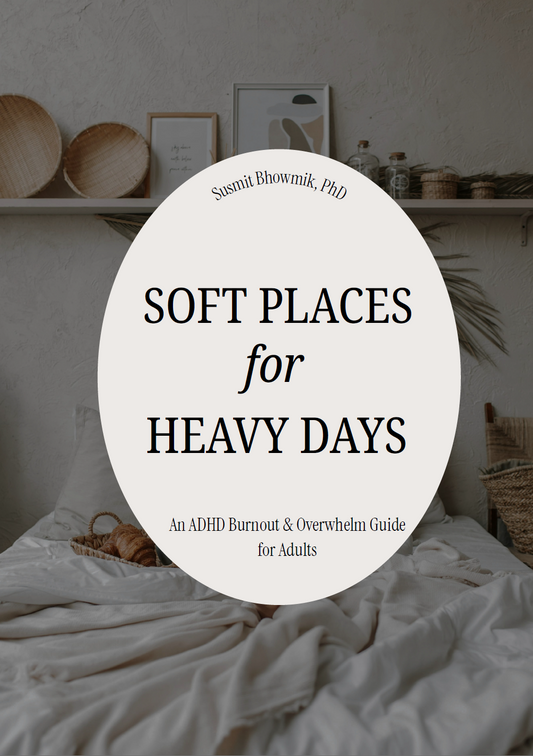 A book cover design featuring a large white oval centered over a softly lit bedroom scene with rumpled white bedding and neutral decor. The title reads 'SOFT PLACES for HEAVY DAYS' with the author name , PhD' at the top of the oval.